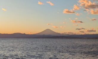 海に沈む夕日と富士山（イメージ写真）